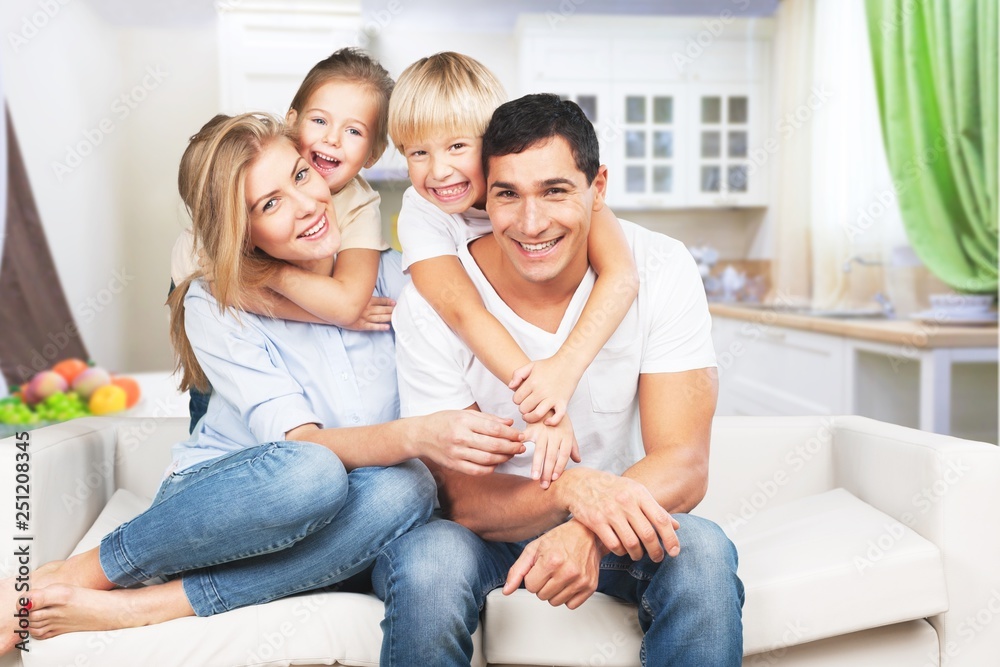 Young  family at home smiling at camera