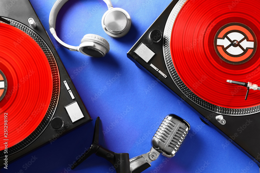 Headphones with modern DJ mixer and microphone color background