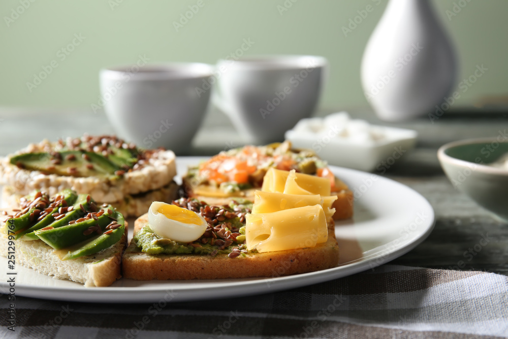 Plate with different tasty sandwiches on table, closeup