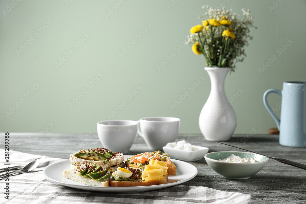 Plate with different tasty sandwiches on table