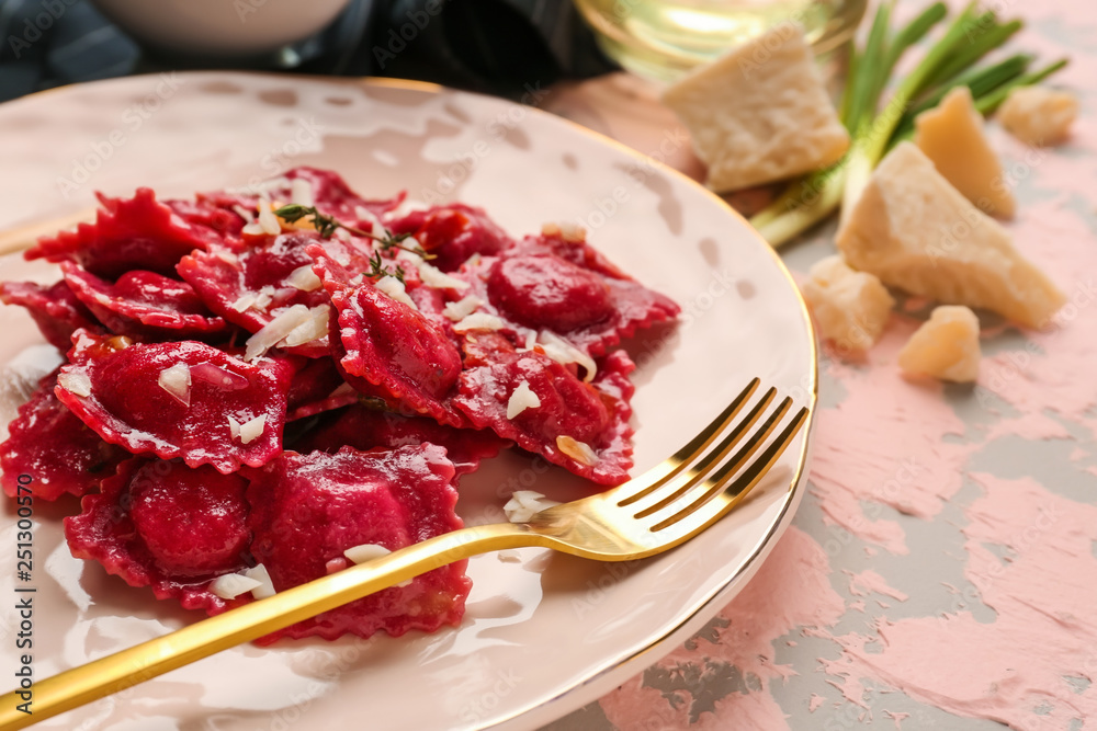 Plate with tasty ravioli on table