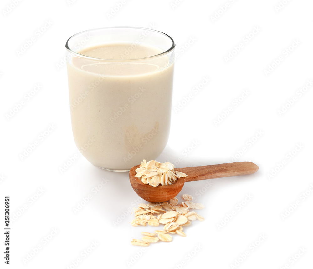 Glass of tasty oat milk on white background