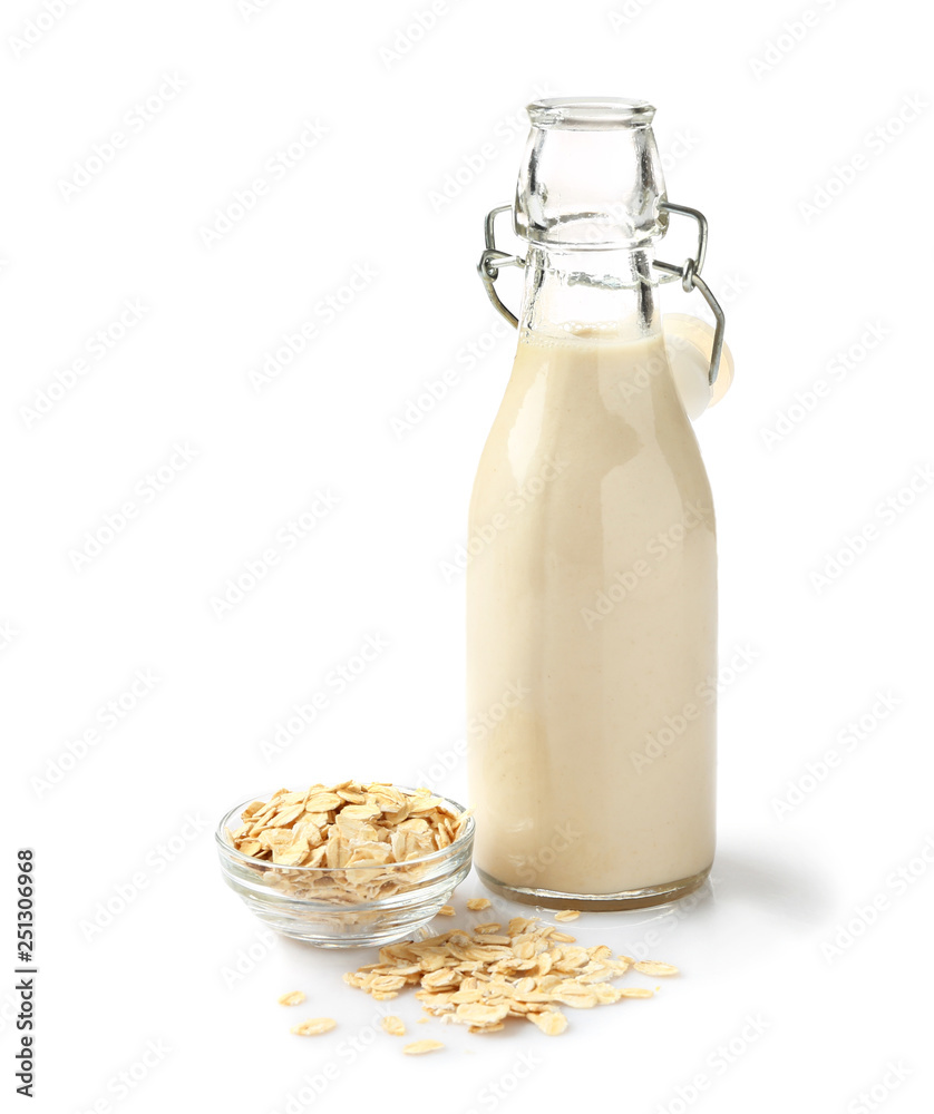 Bottle of tasty oat milk on white background