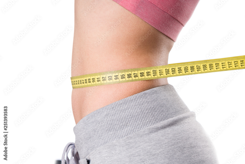 sport, fitness and diet concept, trained belly with measuring tape, health