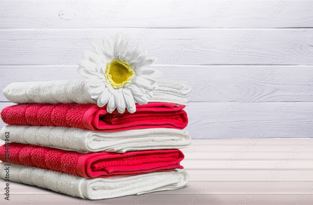 Laundry Basket with colorful towels on background