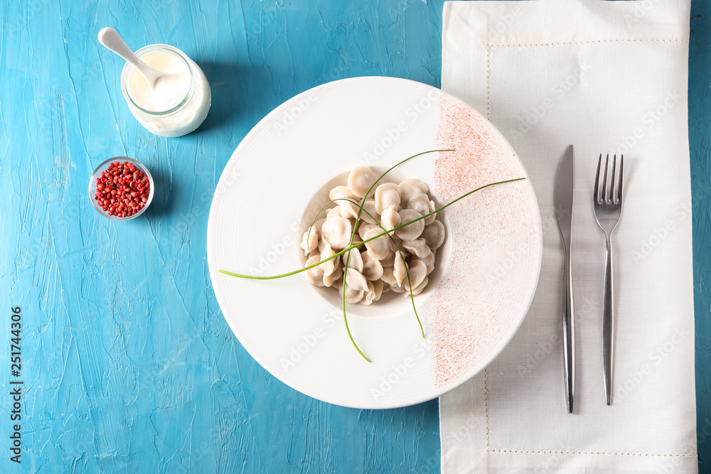 Plate with tasty dumplings on table