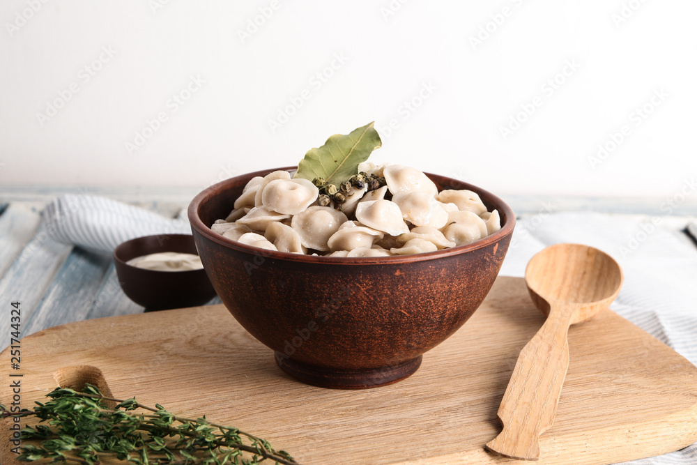 Bowl with tasty dumplings on table