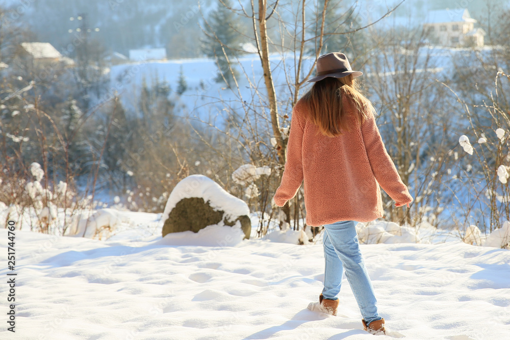 Beautiful woman at snowy mountain resort