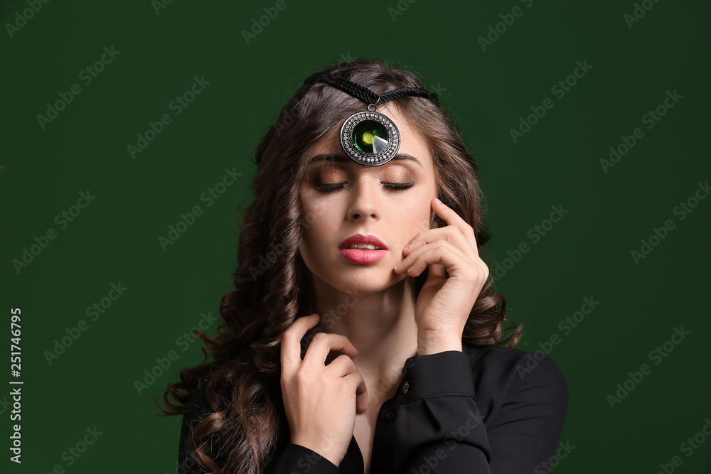 Young woman with beautiful jewelry on dark color background