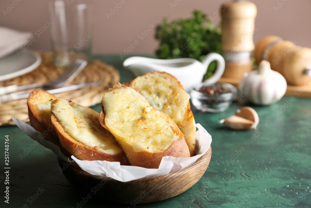 Sliced bread with garlic and cheese on table