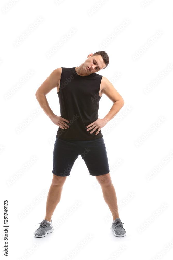 Sporty young man training against white background