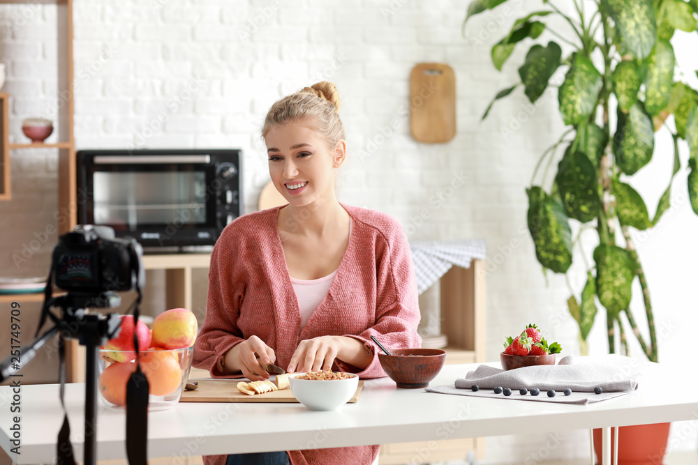 Young female food blogger recording video indoors