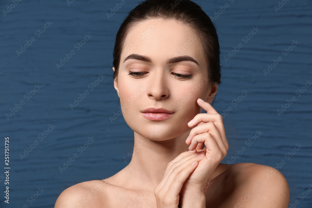 Young woman with beautiful eyebrows on color background