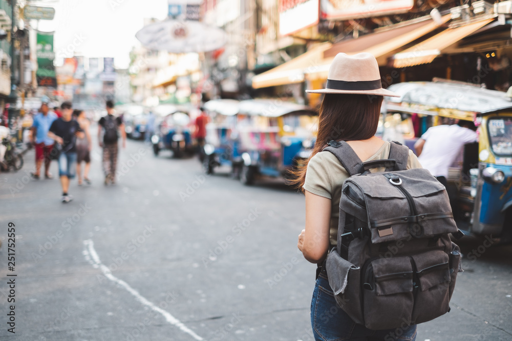 Back view Asian woman tourist backpacker travel in Khao San road, Bangkok, Thailand