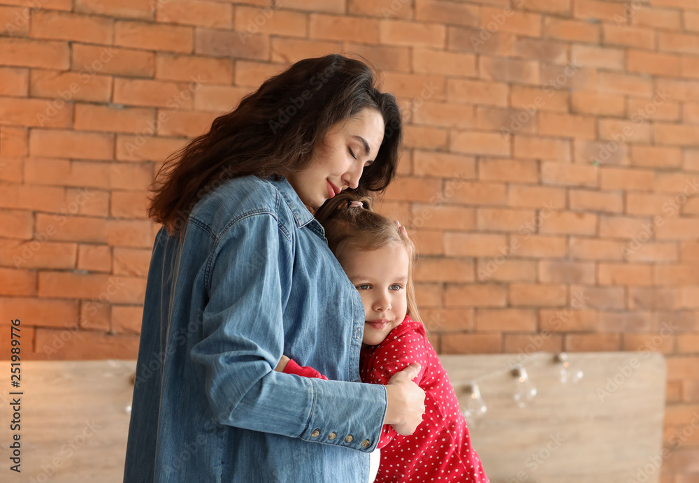 Pregnant mother with little daughter at home