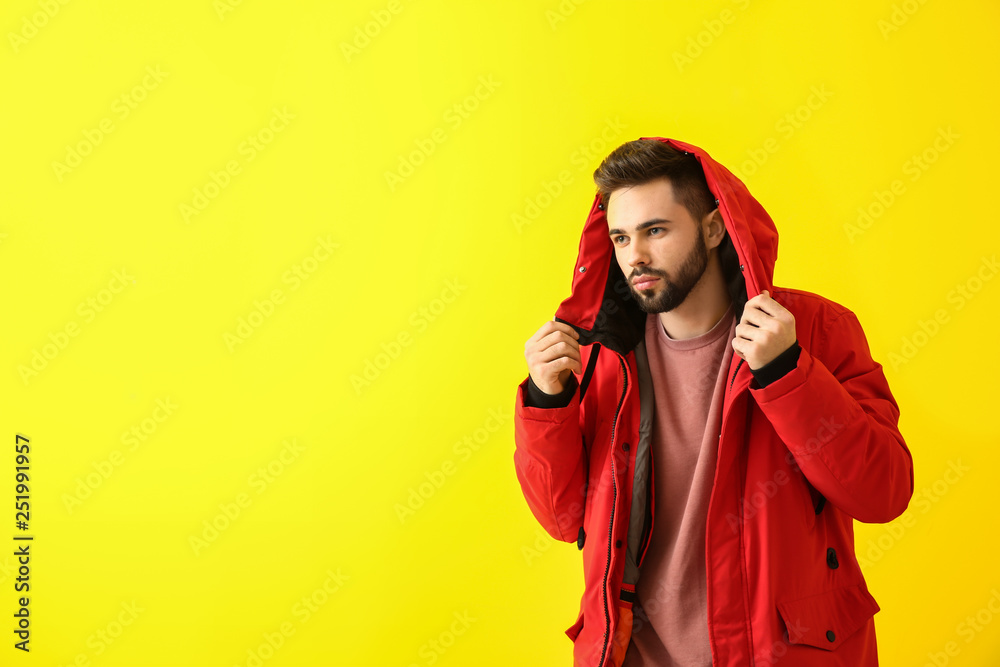 Fashionable young man on color background