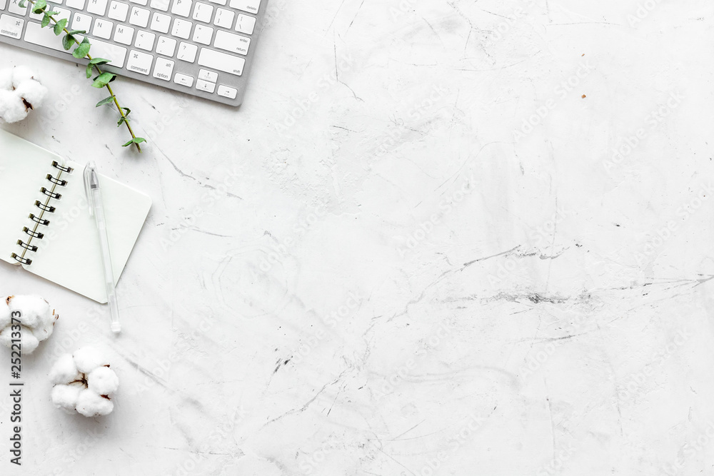 Laptop, cotton branch, notebook on white background flat lay copy space. Minimal freelancer home off