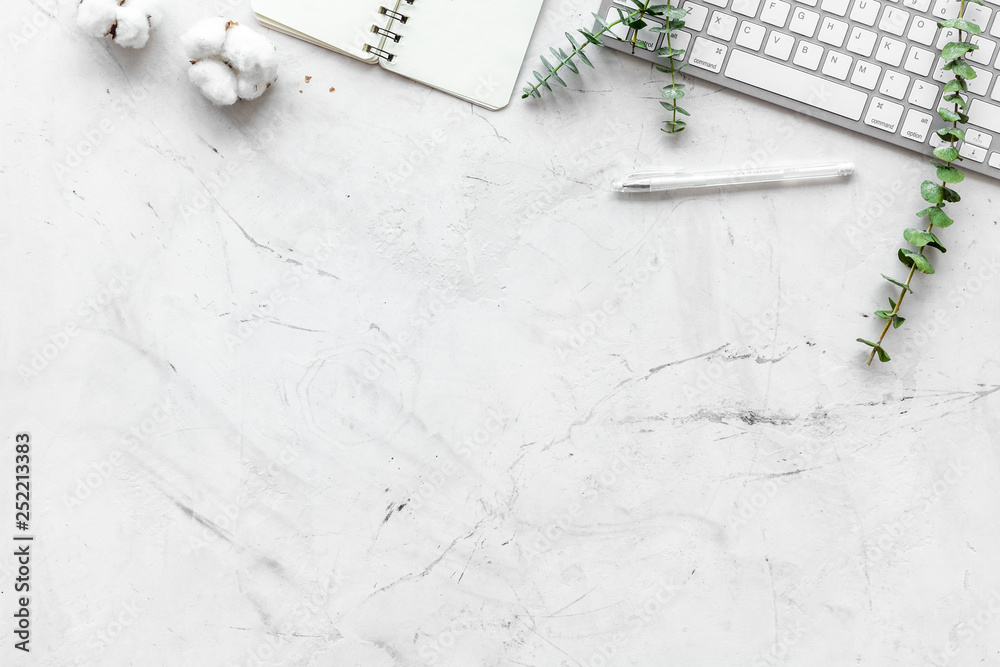 Laptop, cotton branch, notebook on white background flat lay copy space. Minimal freelancer home off