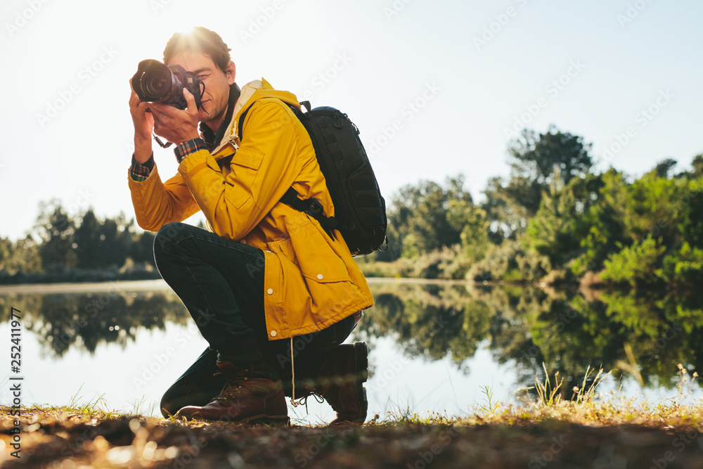 Man taking photos with a digital camera outdoors