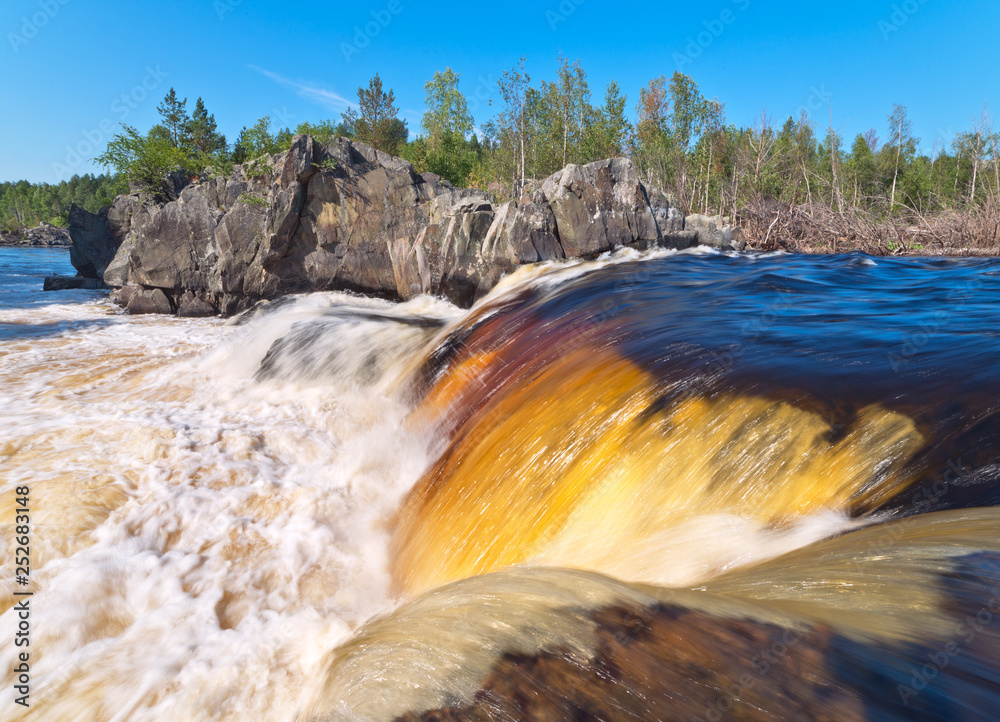 Beautiful wide waterfall on the Karelian river.