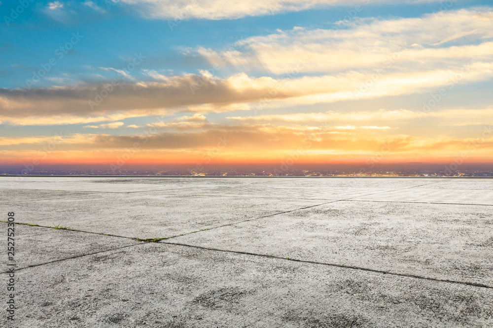 Empty square floor and modern city skyline with beautiful colorful clouds at sunset