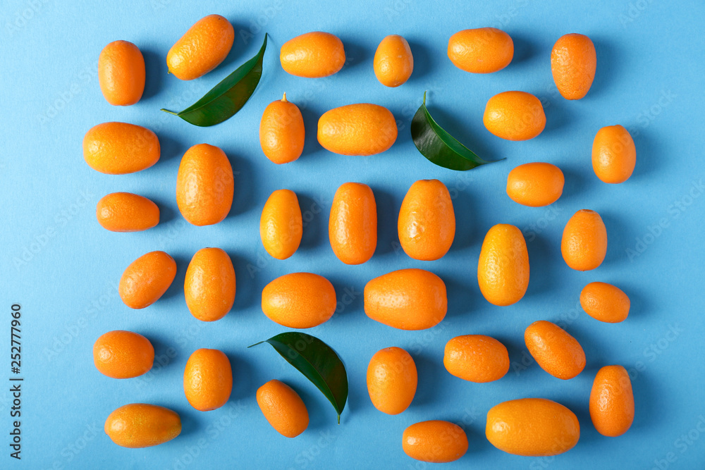 Delicious kumquat fruit on color background