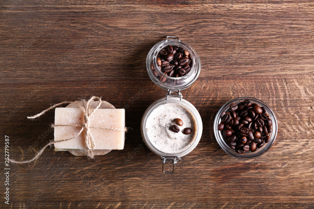 Jar with natural scrub and soap on wooden table