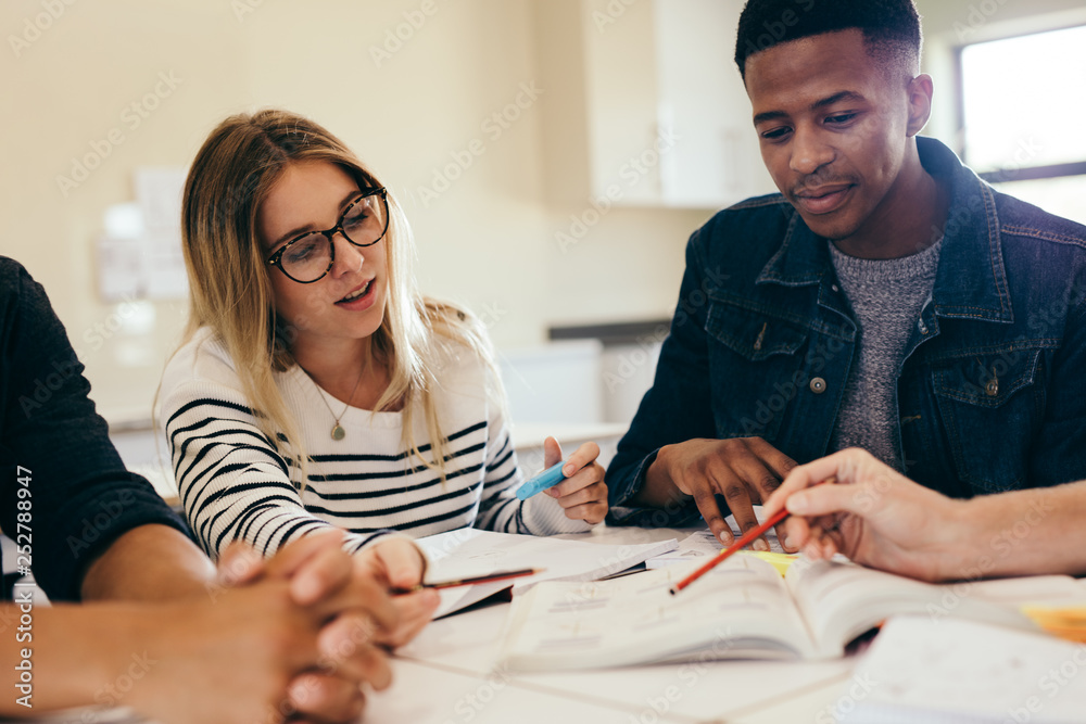 College students studying together in a library