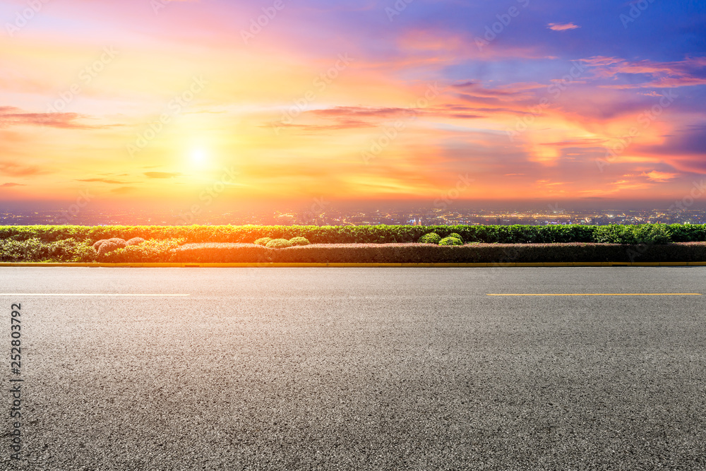 Asphalt road through the modern city above in Shanghai at sunset