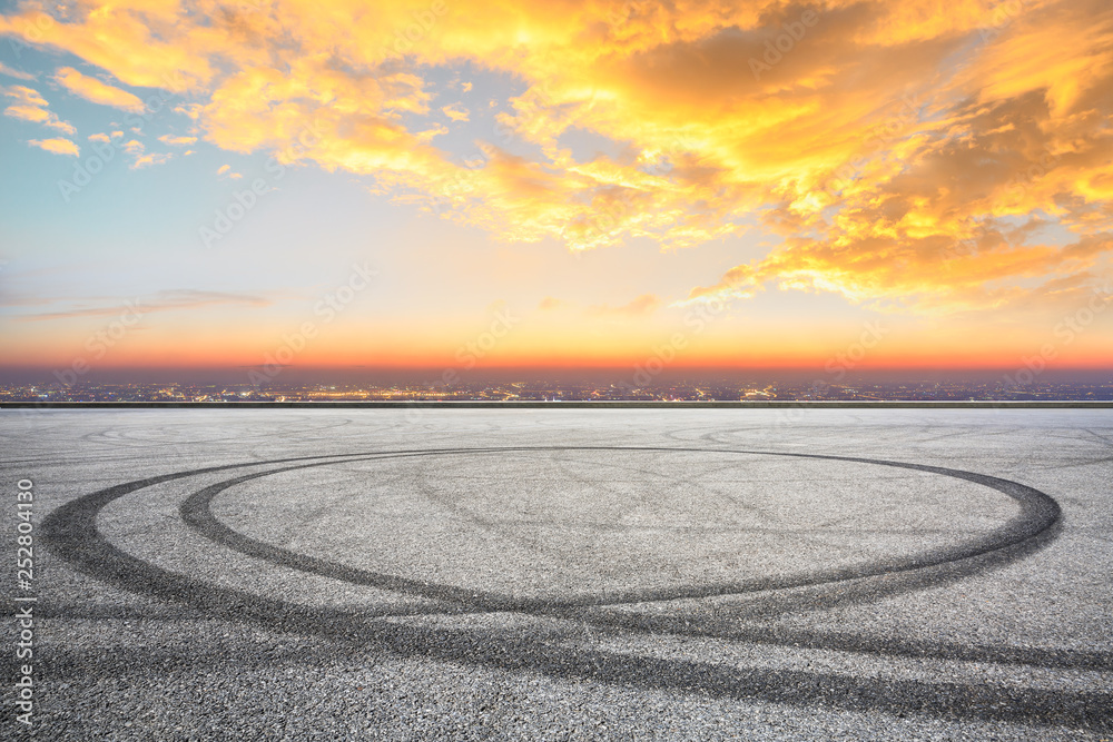 Empty asphalt square ground and city skyline with beautiful clouds at sunset