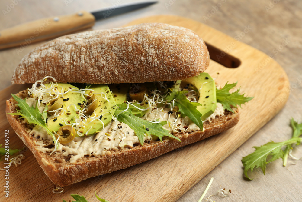 Fresh tasty sandwich on wooden board, closeup