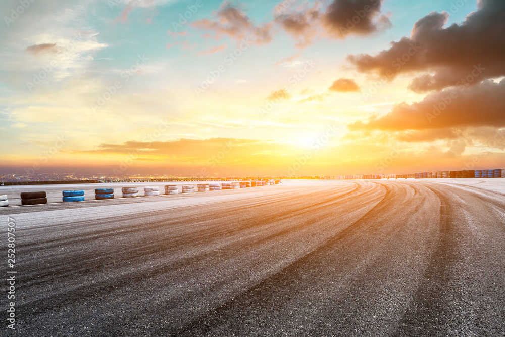 Empty asphalt square ground and city skyline with beautiful clouds at sunset