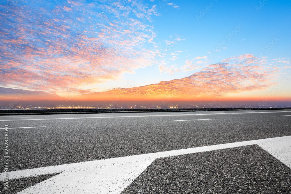 Asphalt road through the modern city above in Shanghai at sunset