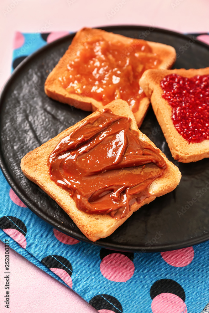 Tasty toasts with spreading on color background