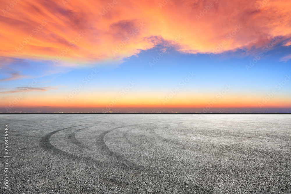 Empty asphalt square ground and city skyline with beautiful clouds at sunset