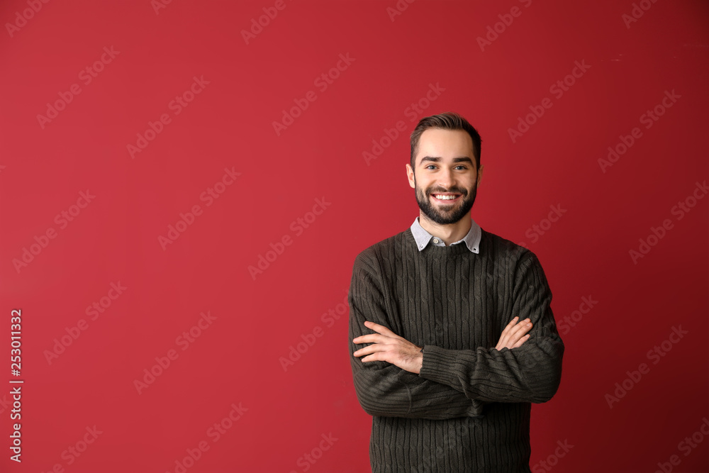 Portrait of young businessman on color background