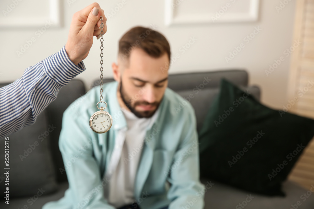 Young man during hypnosis session in psychologists office