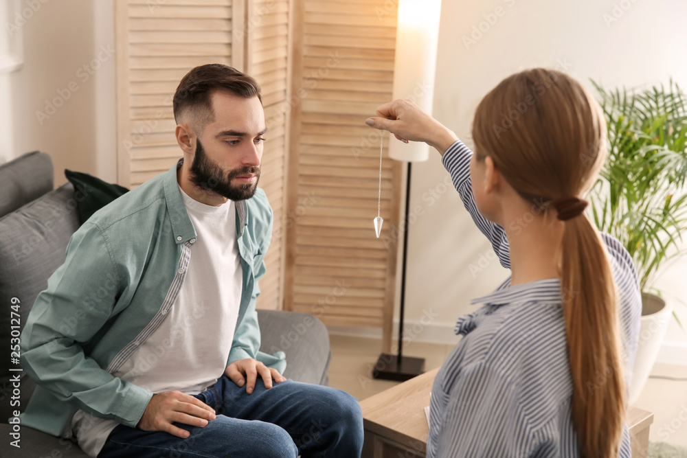 Young man during hypnosis session in psychologists office