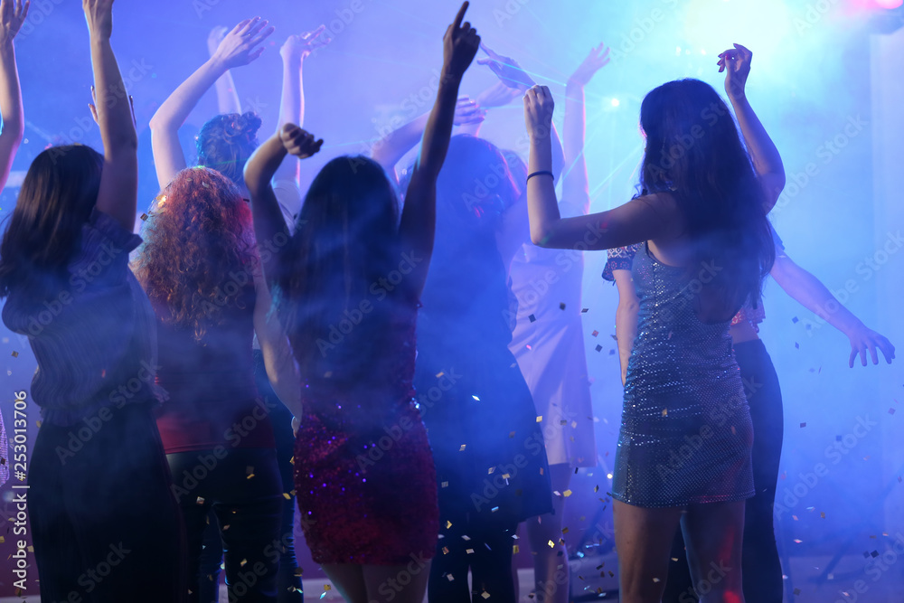 Beautiful young women dancing in night club