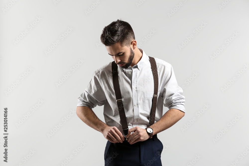 Fashionable young man on light background