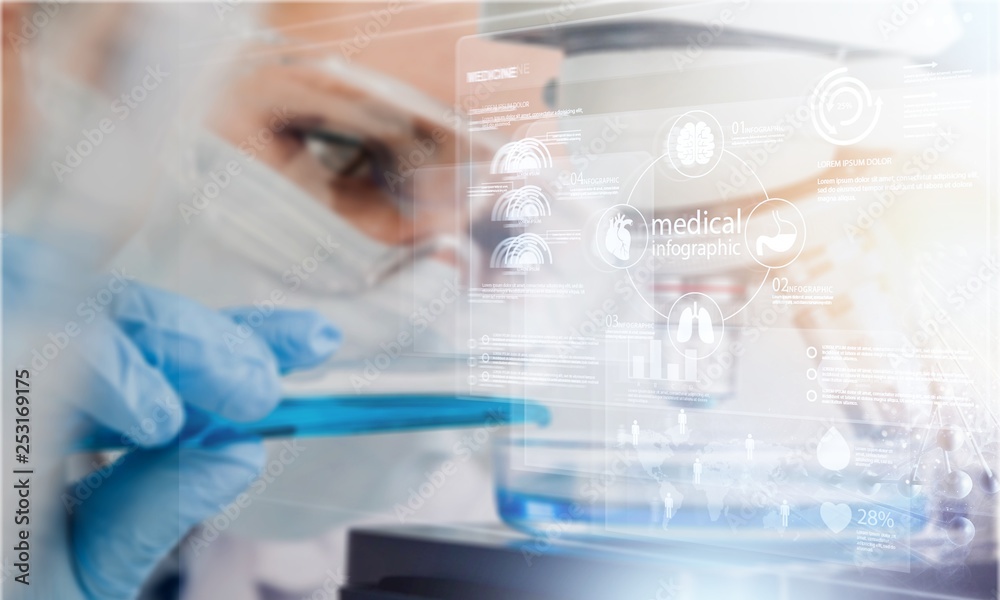 Female scientist in mask and glasses working with microscope