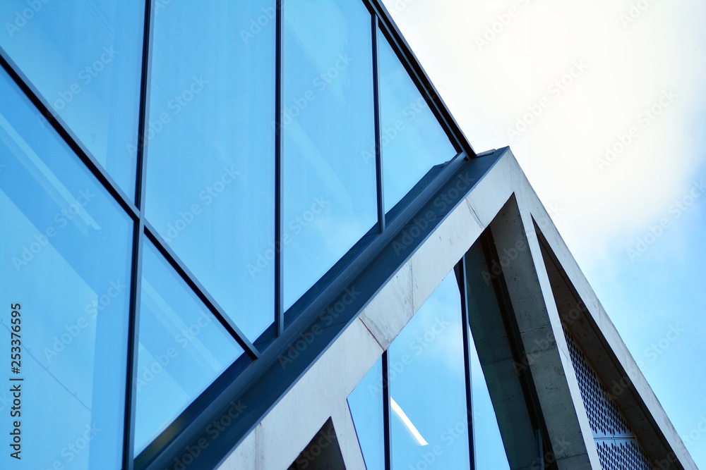 Abstract image of looking up at modern glass and concrete building. Architectural exterior detail of