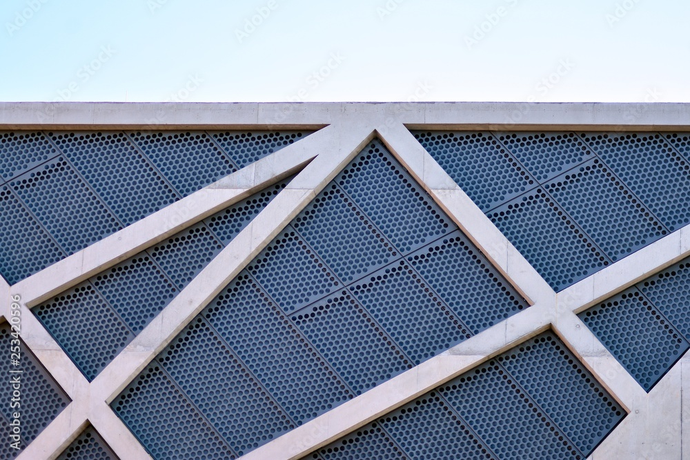 Abstract image of looking up at modern glass and concrete building. Architectural exterior detail of