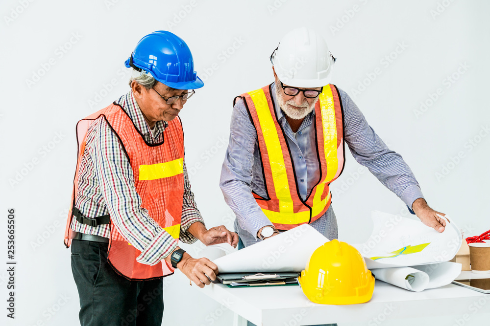 Senior engineers and architect working with construction plan. House building concept.