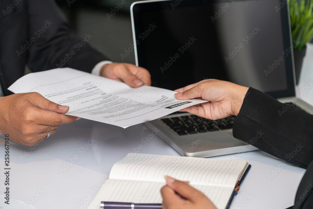 Close up view of employee candidate hands CV resume document to the interviewer HR human resources d