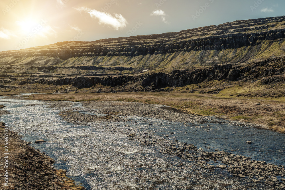 Shallow river stream nature terrain in countryside. Four-wheel drive vehicle track.