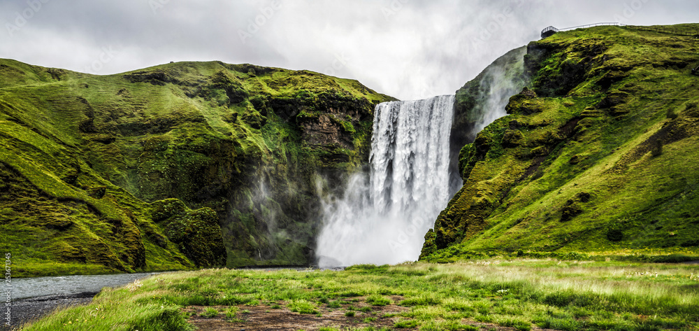 Beautiful scenery of the majestic Skogafoss Waterfall in countryside of Iceland in summer. Skogafoss