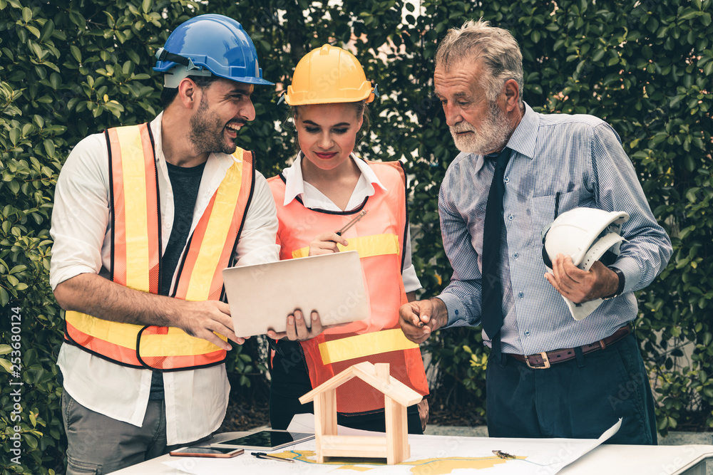 Engineer, architect and business man working on the engineering project at construction site. House 