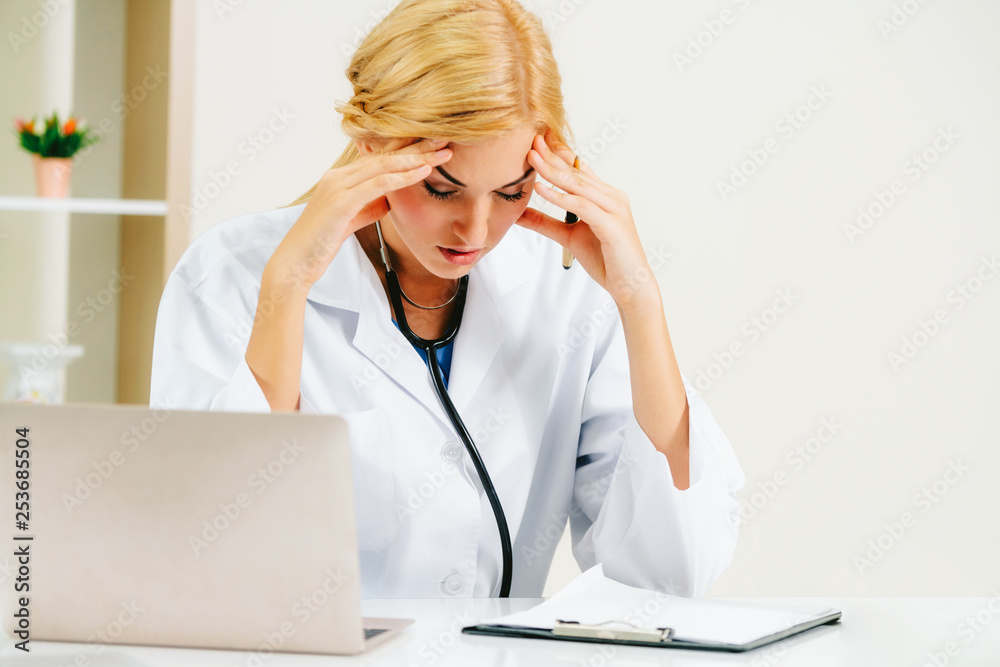 Serious doctor working in hospital office. Medical and healthcare concept.