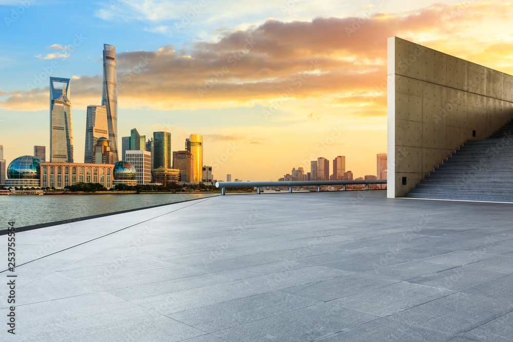 Empty square floor and modern city buildings in Shanghai at dusk